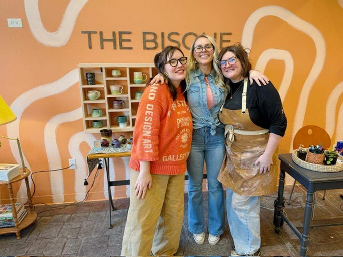 Teri Erasmus (center) poses for a photo with store manager Emily Streets (left) and studio member Emilee Wendt (right) on grand opening day for The Bisque in Port Orchard, Wash., Saturday, Jan. 26, 2026.