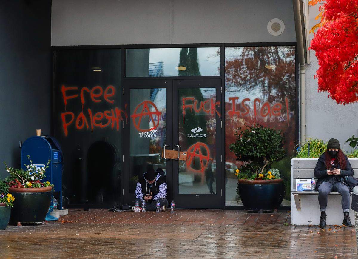 The front entrance of The Northwest Seaport Alliance building at the Port of Tacoma is covered in graffiti during the protest on Nov. 6, 2023.
