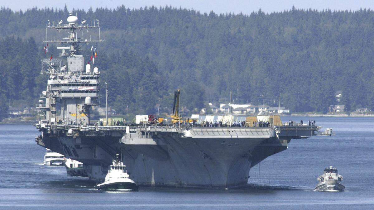 Aided by tugboats the USS Abraham Lincoln is guided on its way to the Puget Sound Naval Shipyard of Bremerton in 2003. The shipyard is holding a job fair at the Greater Tacoma Convention center.