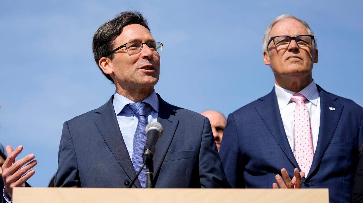 Washington Attorney General Bob Ferguson speaks as Washington Gov. Jay Inslee, right, looks on. Ferguson officially launched his campaign for governor on Saturday, Sept. 9, 2023. (AP Photo/Lindsey Wasson)