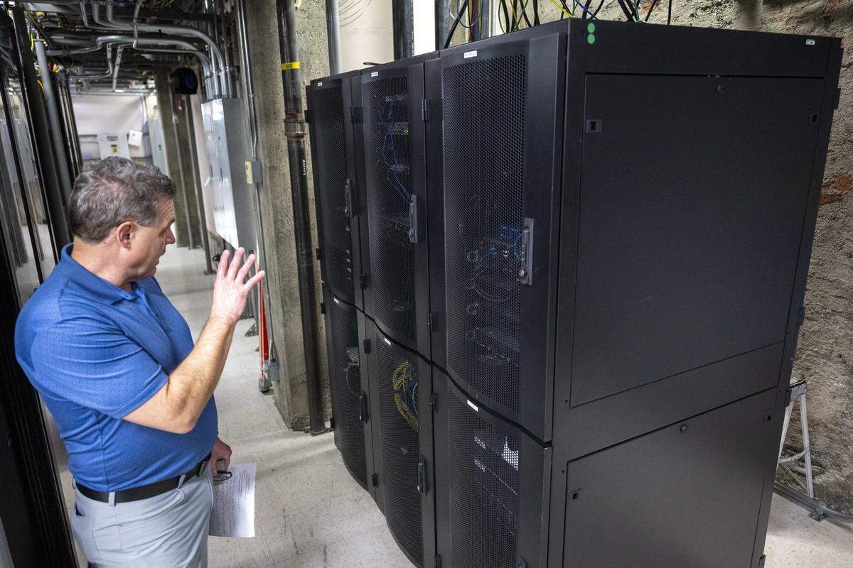 Derik Dahlke, vice president of sales with Colocation Northwest in Tacoma, stands in front of a split server cabinet on Wednesday, Feb. 18, 2026, in Tacoma, Wash. The split size allows for tenants who need less capacity, Dahlke shared.