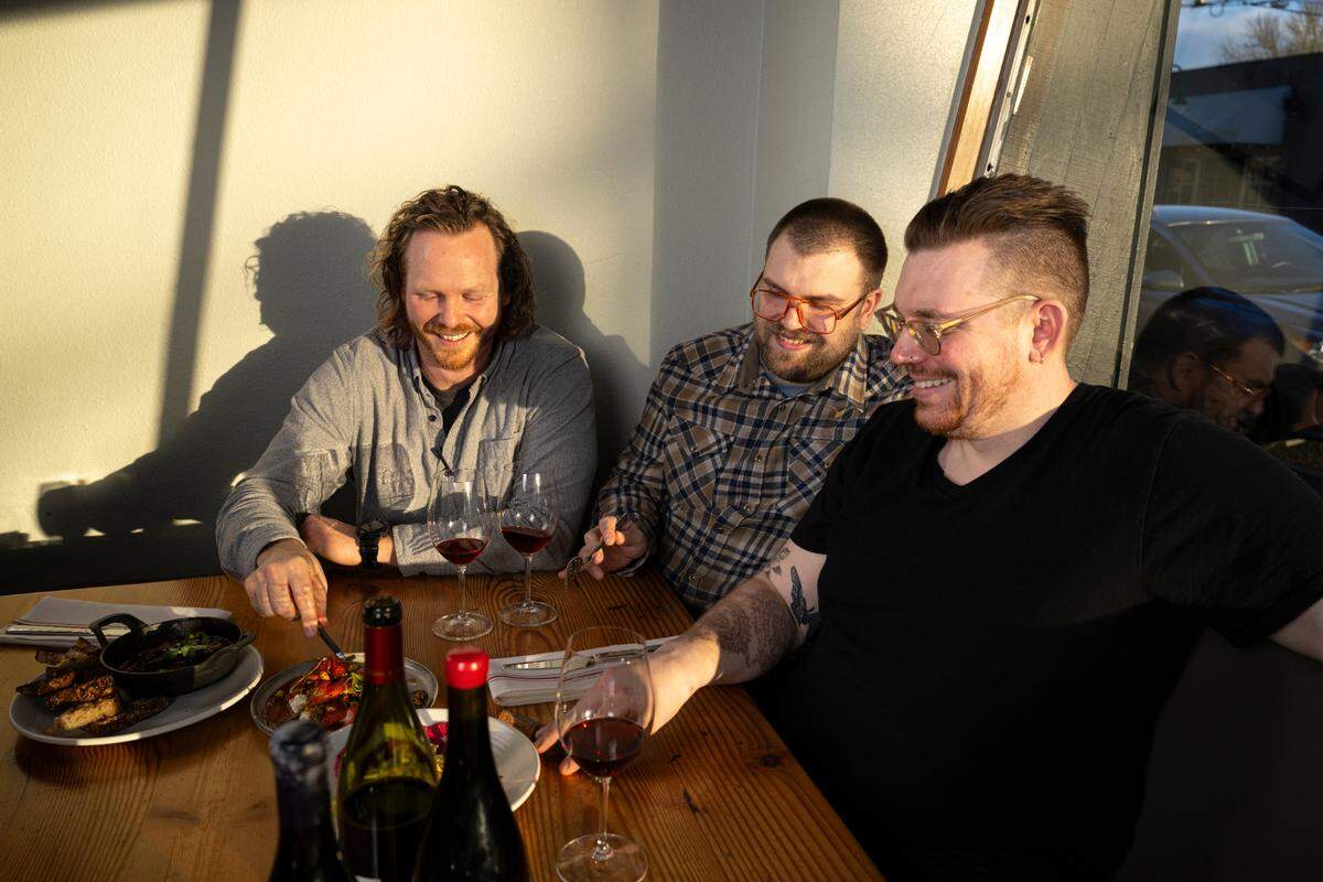 Bray (left) with his sommelier and business partner Trevor Hamilton (center) and chef de cuisine Craig Tronset shared a moment at The Table in February. The latter two are opening a new restaurant in Proctor.