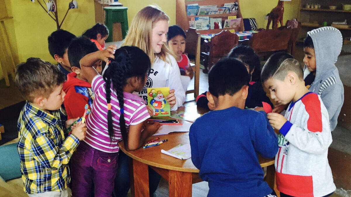 Henderson Bay High School student Ashley Phillips shared a moment with local Mayan children at the free Montessori school at Opal House in Guatemala last year.