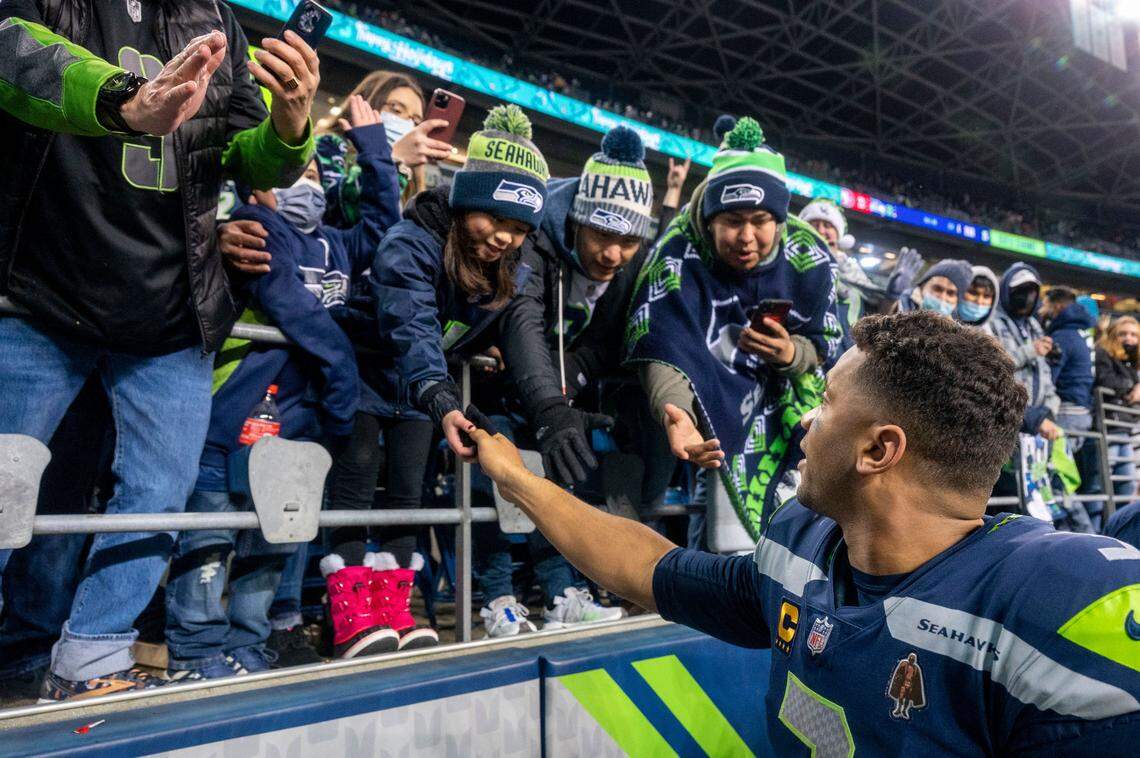 Seattle quarterback Russell Wilson (3) thanks the fans after helping the Seahawks to a 30-23 win over San Francisco 49ers on Sunday at Lumen Field in Seattle.
