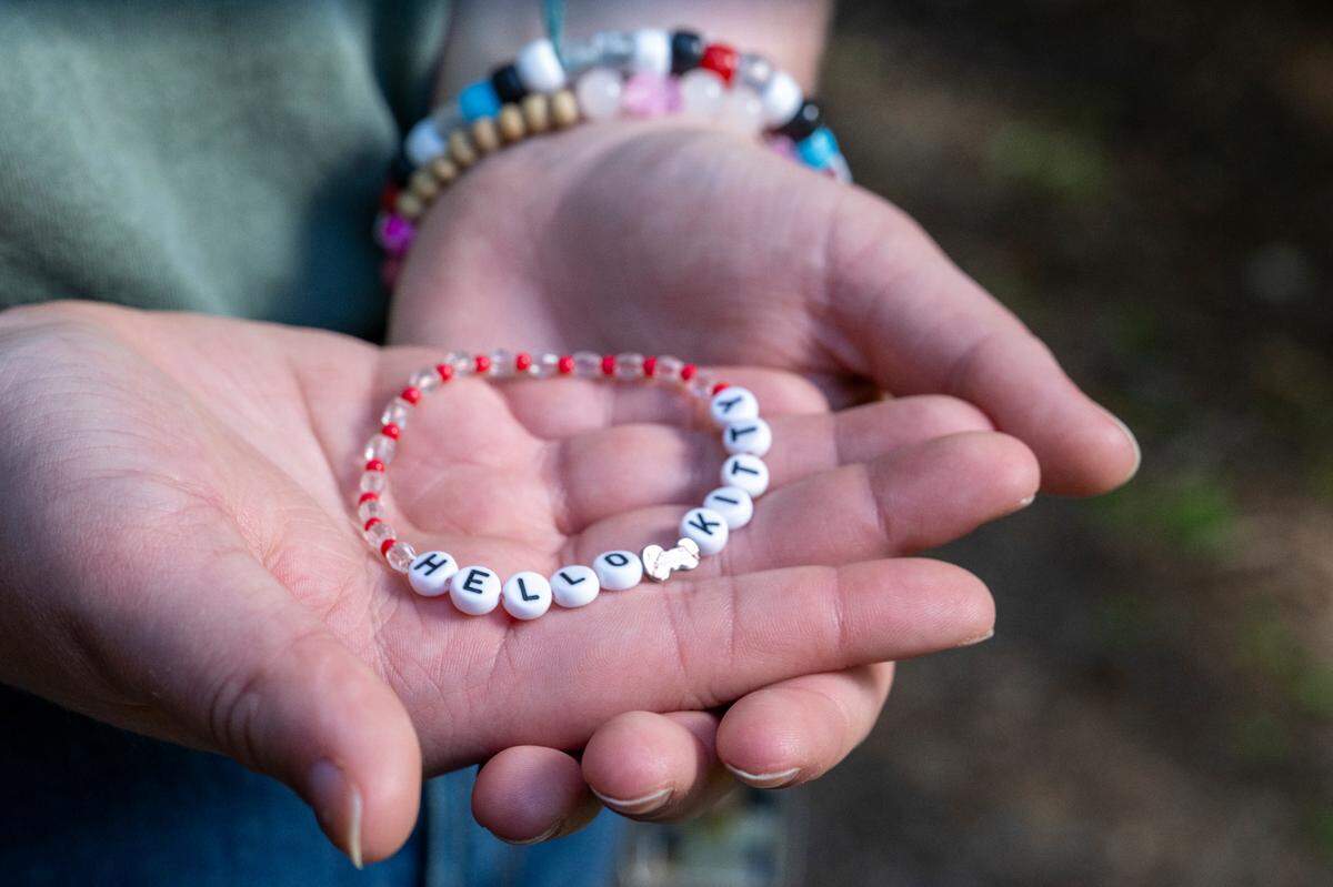Rory holds a bracelet made for them by a friend at the Oasis Youth Center on Thursday, May 1, 2025, at the Rhododendron Garden at Point Defiance Park in Tacoma.