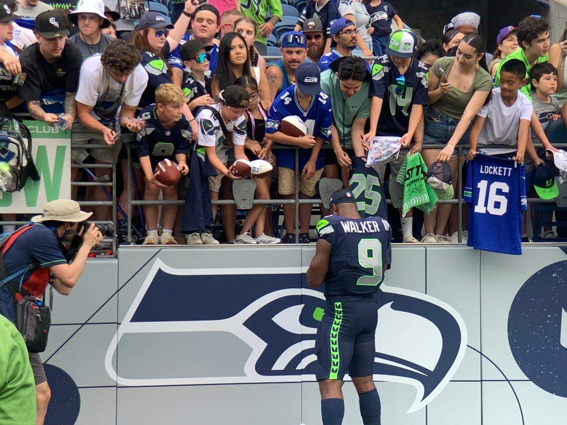 Running back Kenneth Walker makes the patrons happy immediately following the Seahawks’ annual fan fest practice at Lumen Field during training camp, Saturday, Aug. 3, 2024, in Seattle.