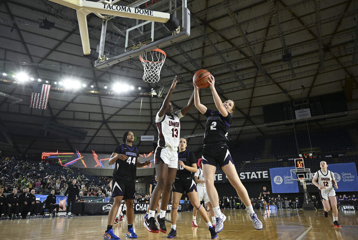 Sumner guard Mae Cocke (2) takes control of a rebound ball with pressure from Union wing Leah Samuel (13) during the quarterfinal round of the 4A State Tournament at the Tacoma Dome, on Thursday, March 5, 2026, in Tacoma, Wash.