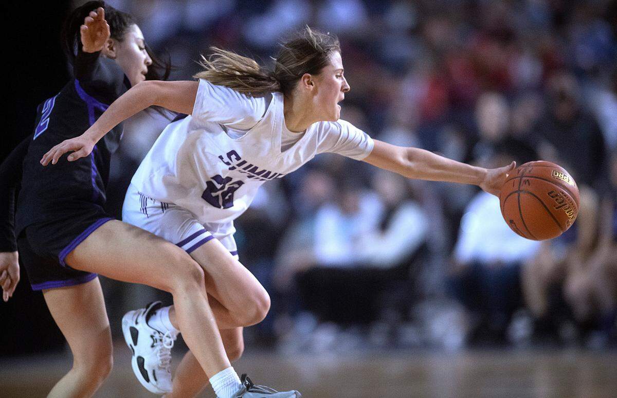 Sumner’s Lainee Houilloon beats Pasco’s Leanna Lepe in a race to a loose ball during Friday evening’s semifinal game of the WIAA 4A Girls Basketball State Championships tournament in the Tacoma Dome in Tacoma, Washington, on Friday, March 4, 2022.