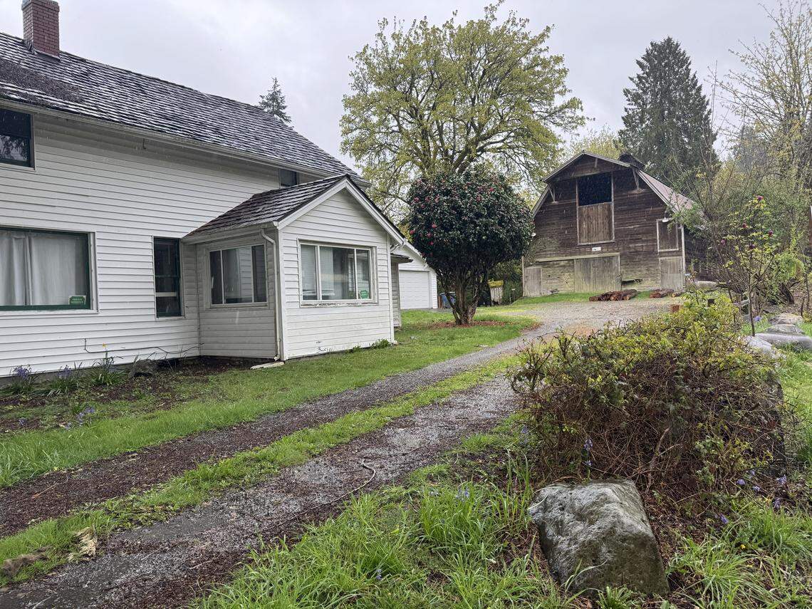 Wilkinson Barn, pictured Tuesday, April 14, 2026 in Gig Harbor, Wash., is on the city of Gig Harbor’s list of historic register sites and was built in 1915, according to the Pierce County Assessor-Treasurer’s office. The farmhouse next to it was built in 1920.