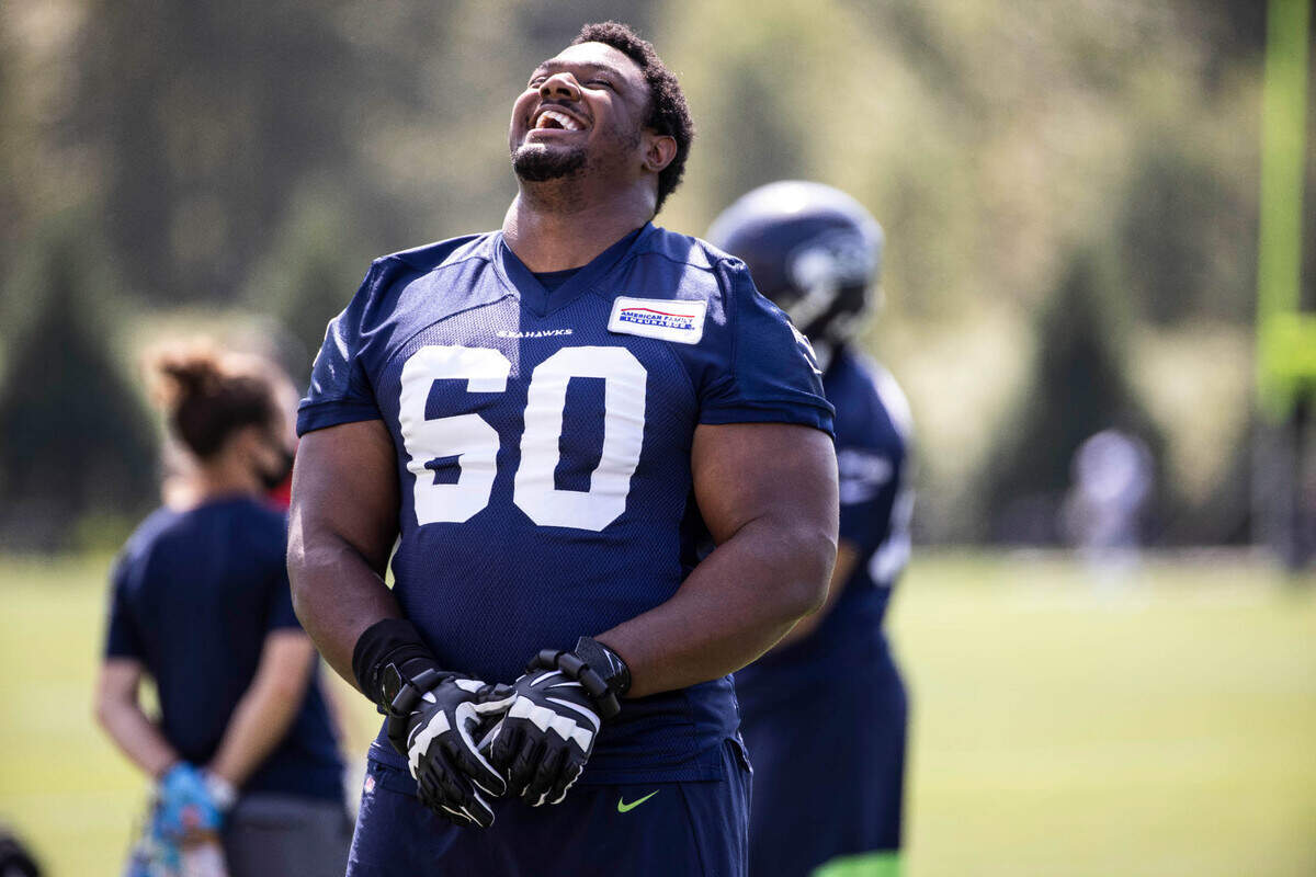 Seahawks guard Phil Haynes lets out a roar of laughter as he warms up for Thursday’s practice. The Seattle Seahawks practiced Thursday, August 13, 2020 at the VMAC in Renton, WA.