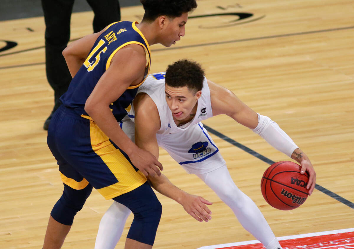UC Santa Barbara’s Jaquori McLaughlin (3) keeps possession of the ball from UC Irvine’s Jeron Artest (15) during the second half of an NCAA college basketball game for the championship of the Big West Conference men’s tournament Saturday, March 13, 2021, in Las Vegas. (AP Photo/Ronda Churchill)