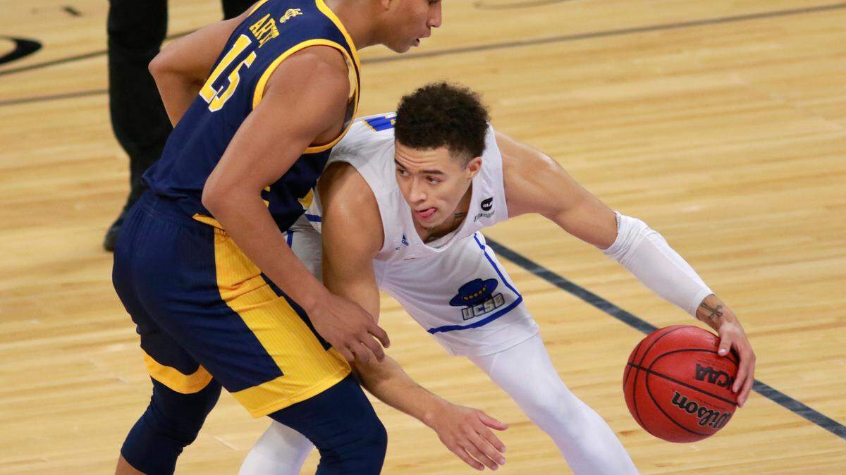 UC Santa Barbara’s Jaquori McLaughlin (3) keeps possession of the ball from UC Irvine’s Jeron Artest (15) during the second half of an NCAA college basketball game for the championship of the Big West Conference men’s tournament Saturday, March 13, 2021, in Las Vegas. (AP Photo/Ronda Churchill)