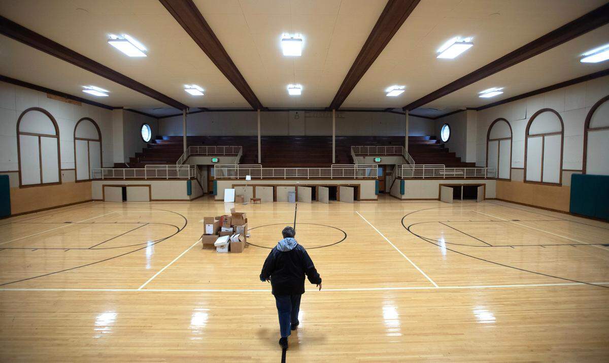 Wendy Freeman, co-secretary of the Parkland Community Association, walks through the gymnasium in the former Parkland School building in Parkland, Washington, on Tuesday, June 4, 2024. The association purchased the building with plan of turning it into a community center and multi-agency hub.