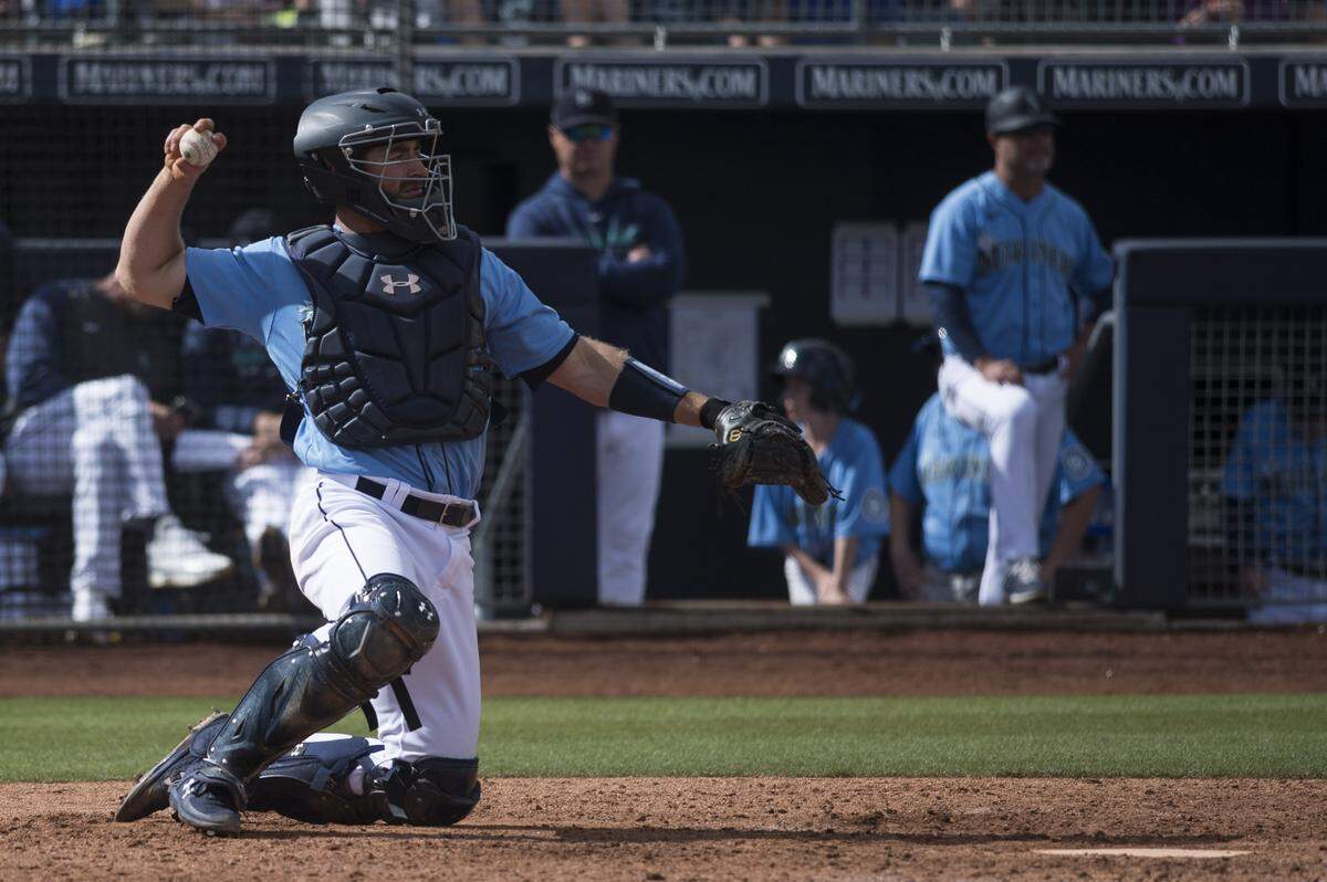 Seattle Mariners catcher Tom Murphy throws the ball back to his pitcher between innings in a spring training game against the Rockies on Monday, March 2, 2020 at Peoria Stadium in Peoria, Ariz.