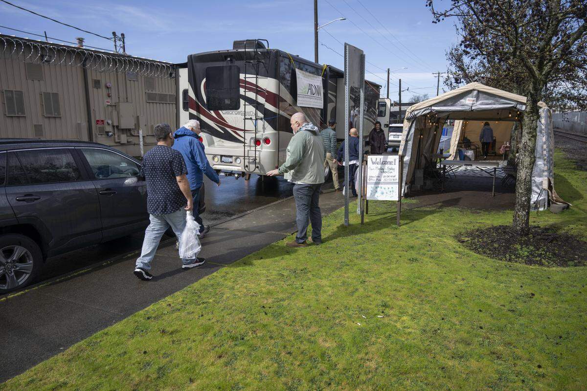 Recently released detainees are guided by volunteers to the welcome center run by Advocates for Immigrants in Detention Northwest on Friday, March 20, 2026, outside of the Northwest ICE Processing Center in Tacoma, Wash. They are offered clothing, food, other supplies and assistance with travel.