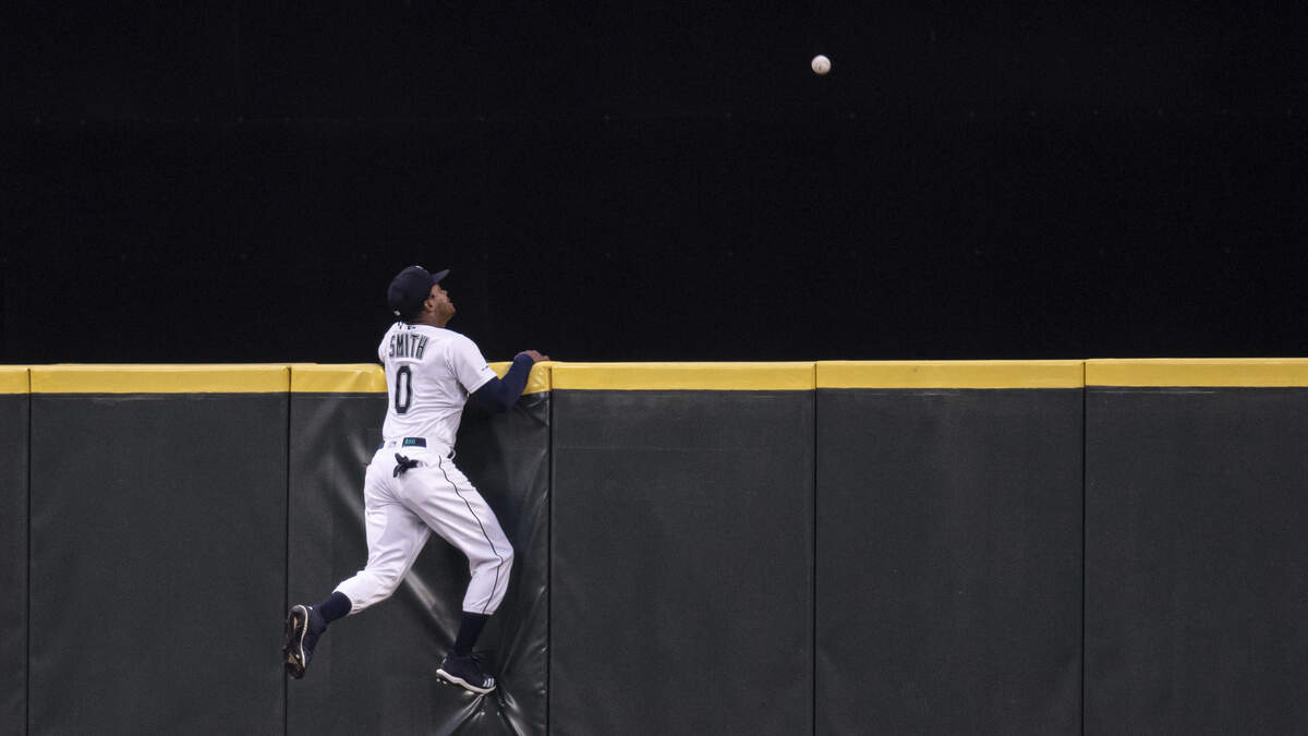 Seattle Mariners center fielder Mallex Smith climbs the wall, but can’t get to a three-run home run by Minnesota Twins’ Byron Buxton off pitcher Erik Swanson during the fourth inning of a baseball game Thursday, May 16, 2019, in Seattle. (AP Photo/Stephen Brashear)