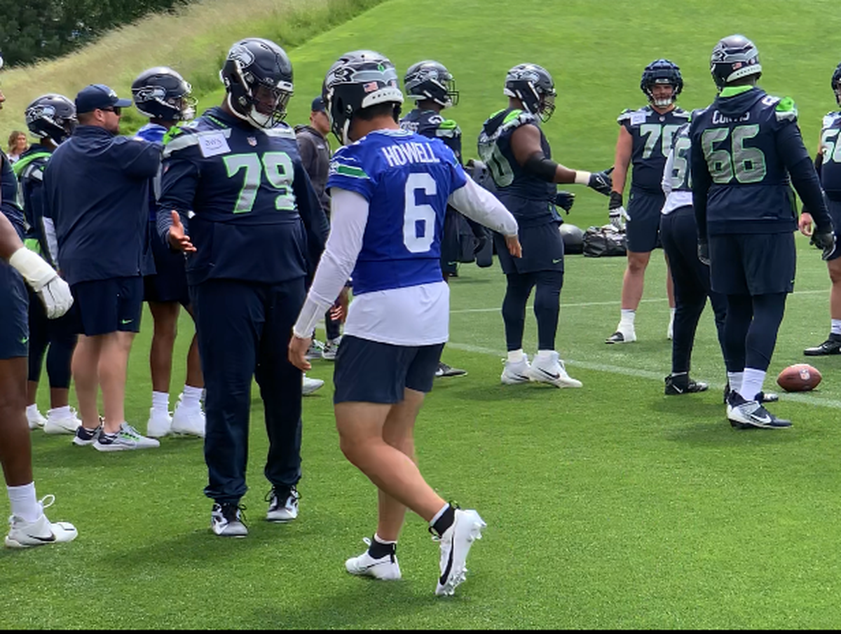 Seahawks quarterback Sam Howell (6) and tackle Raiqwon O’Neal (79) slap hands during an offensive-line drill at the fifth of 10 NFL organized team activities (OTAs) practices at Seattle’s Virginia Mason Athletic Center in Renton, May 30, 2024.