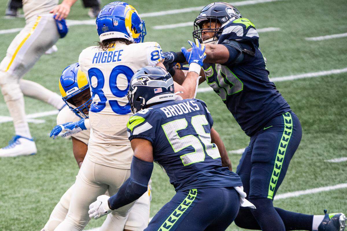 Seattle Seahawks linebacker K.J. Wright pushes Los Angeles Rams tight end Tyler Higbee into Los Angeles Rams running back Malcolm Brown to stop Brown during a fourth-and-goal run by the Rams during the third quarter. The Seattle Seahawks played the Los Angeles Rams in a NFL football game at Lumen Field in Seattle, Wash., on Sunday, Dec. 27, 2020.