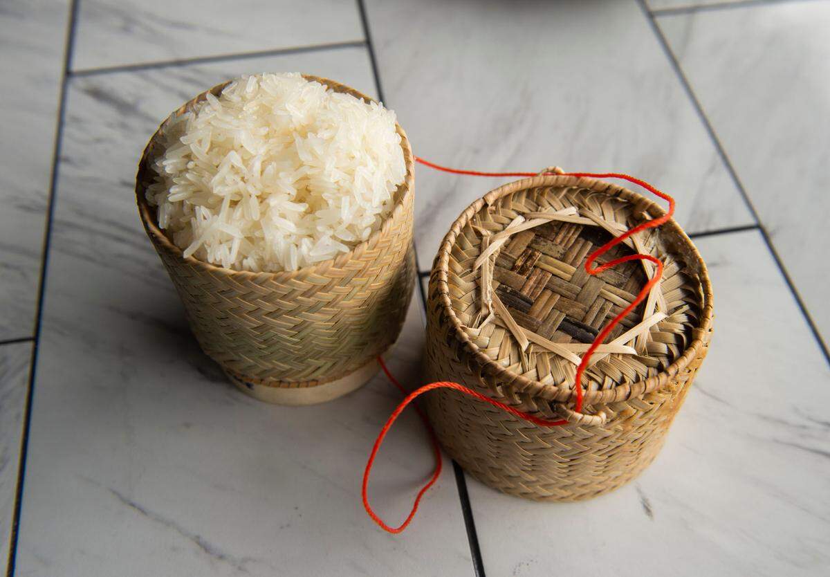 The sticky rice is served in mini bamboo baskets to preserve the moisture and heat.