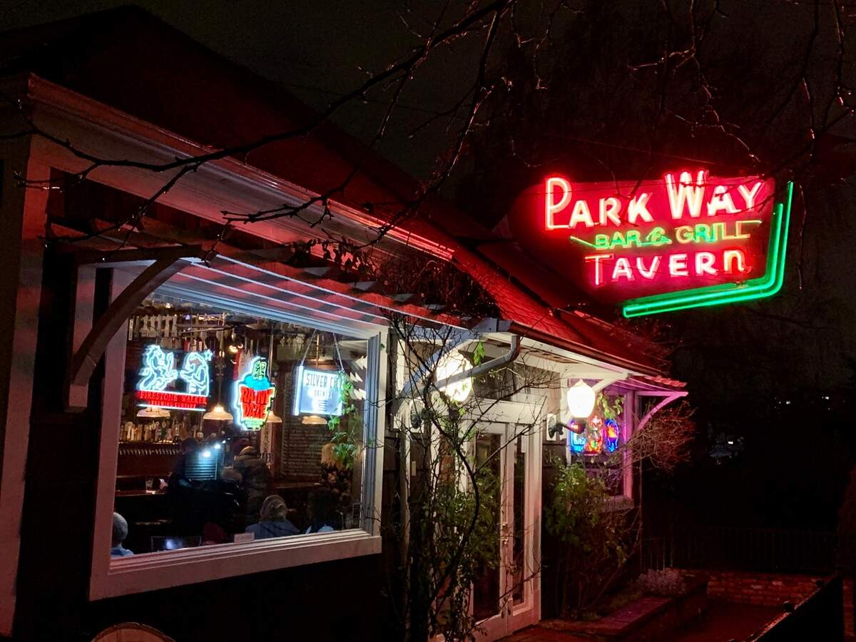 The neon sign of The Parkway in Tacoma beckons legions of fans, in normal times, for pool, shuffleboard, sandwiches, burgers and beer with friends.