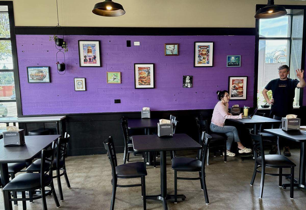 Co-owner Stephanie Kang and operations manager Christopher Poetter discuss soft-opening details in the newly painted dining room on Monday, April 6.
