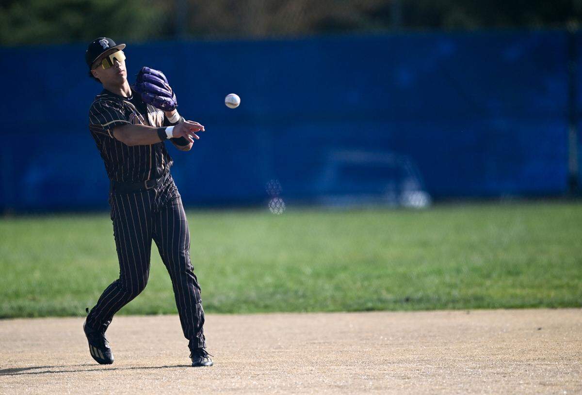 Puyallup’s Mason Pike (3) throws to first base to out a Curtis player during the baseball game at Curtis Senior High School, on Tuesday, April 15, 2025, in University Place, Wash.