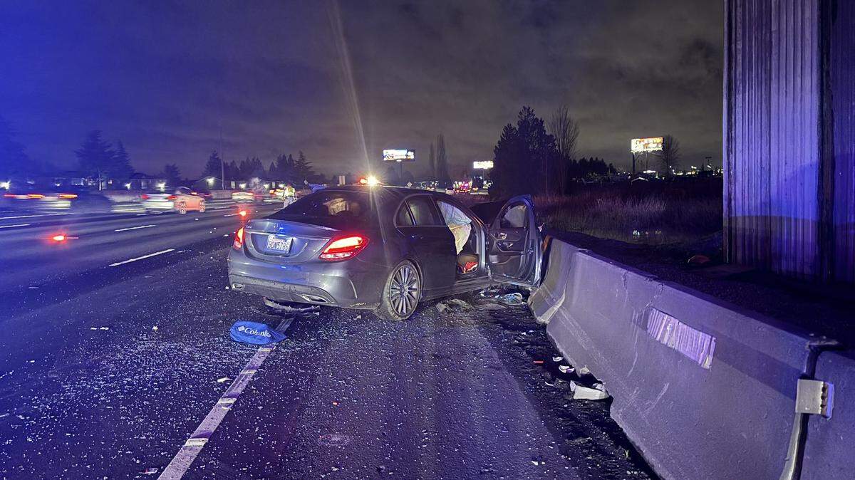 Four people were injured, including a 9-year-old, and one man was charged with vehicular assault after a car collision Friday night on Interstate 5 near Milton.