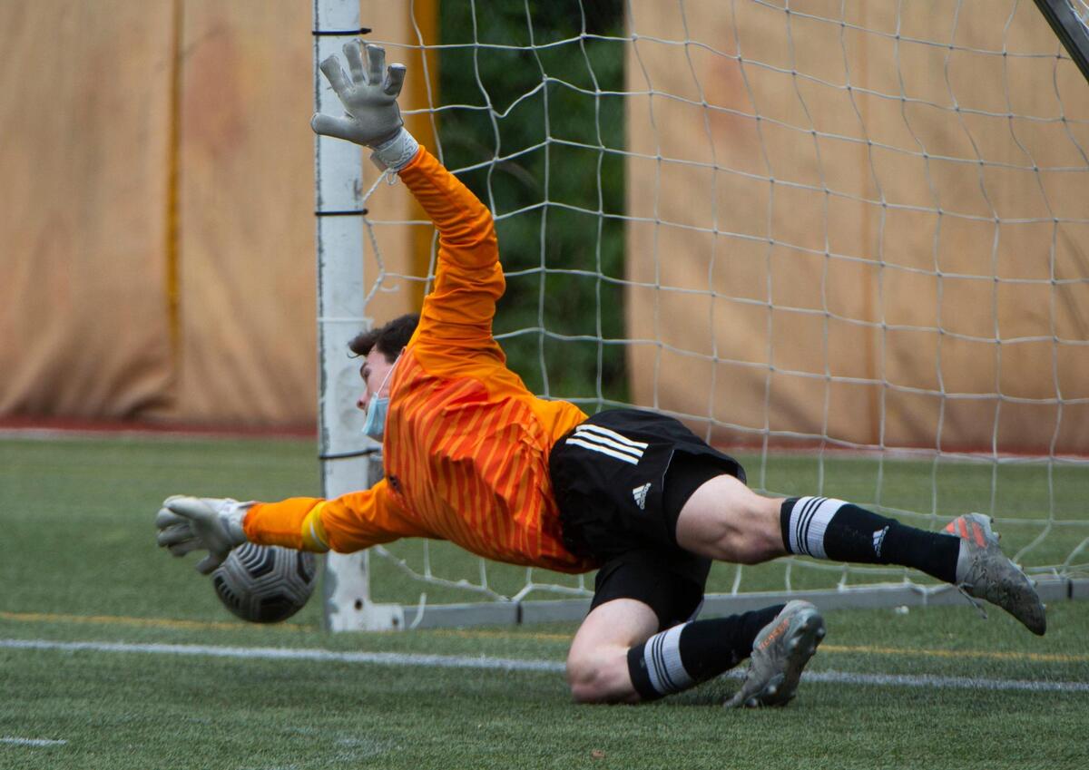 Stadium goalkeeper Hayden Flynn makes a valiant attempt to stop a shot by Wilson forward Abdullah Mousa that put the Rams up 1-0. Wilson defeated the Tigers 2-0 to capture the 3A Pierce County League soccer championship Saturday, May 1, at Stadium High School.