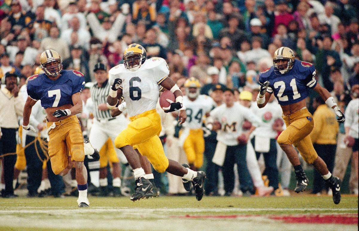 Michigan’s Tyrone Wheatley (6) heads for six point territory during third quarter Rose Bowl action against Washington in Pasadena, Calif. on Jan. 1, 1993. The 88-yard run is the longest touchdown run in Rose Bowl history. Giving chase is Washington’s Josh Moore (7).