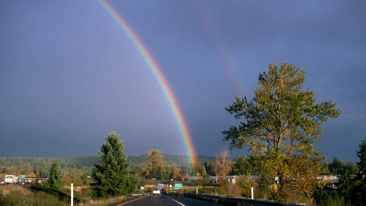 A rainbow shines over the Nisqually Valley north of Lacey, Washington, on Monday, Oct. 16, 2023.