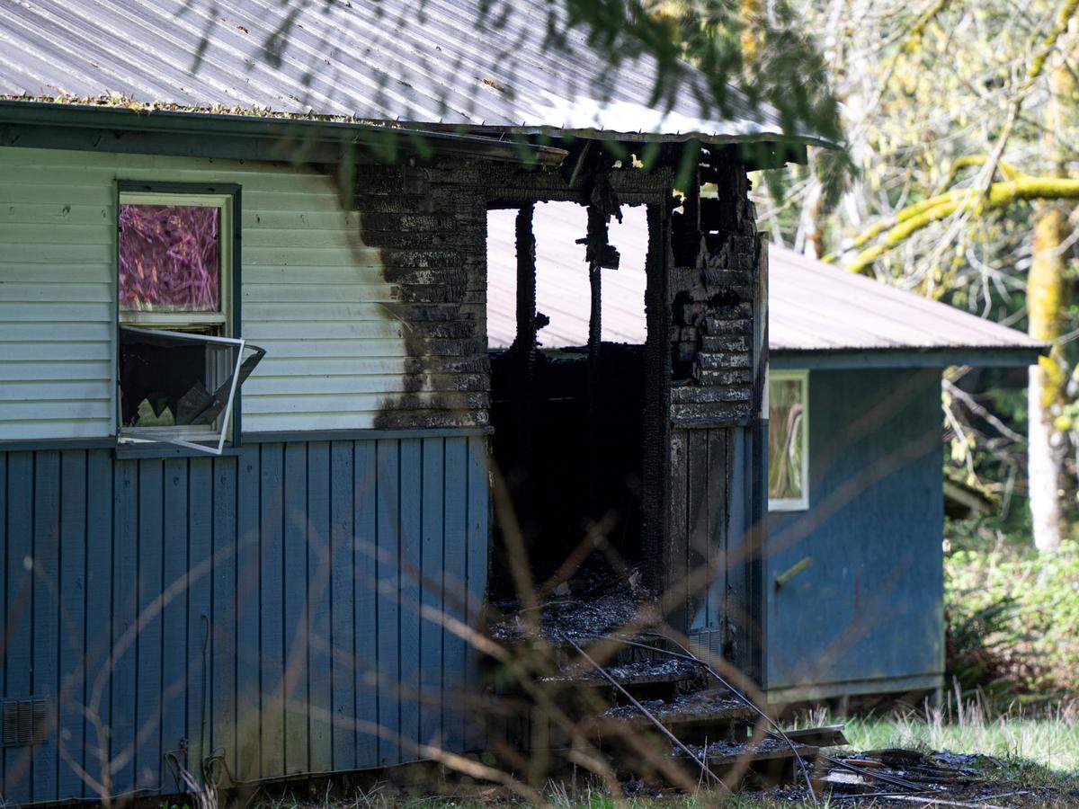 The scene of a suspicious house fire that left two people dead in 15500 block of 14th Avenue Northwest, on Wednesday, April 9, 2025, in the Maplewood area of Pierce County.