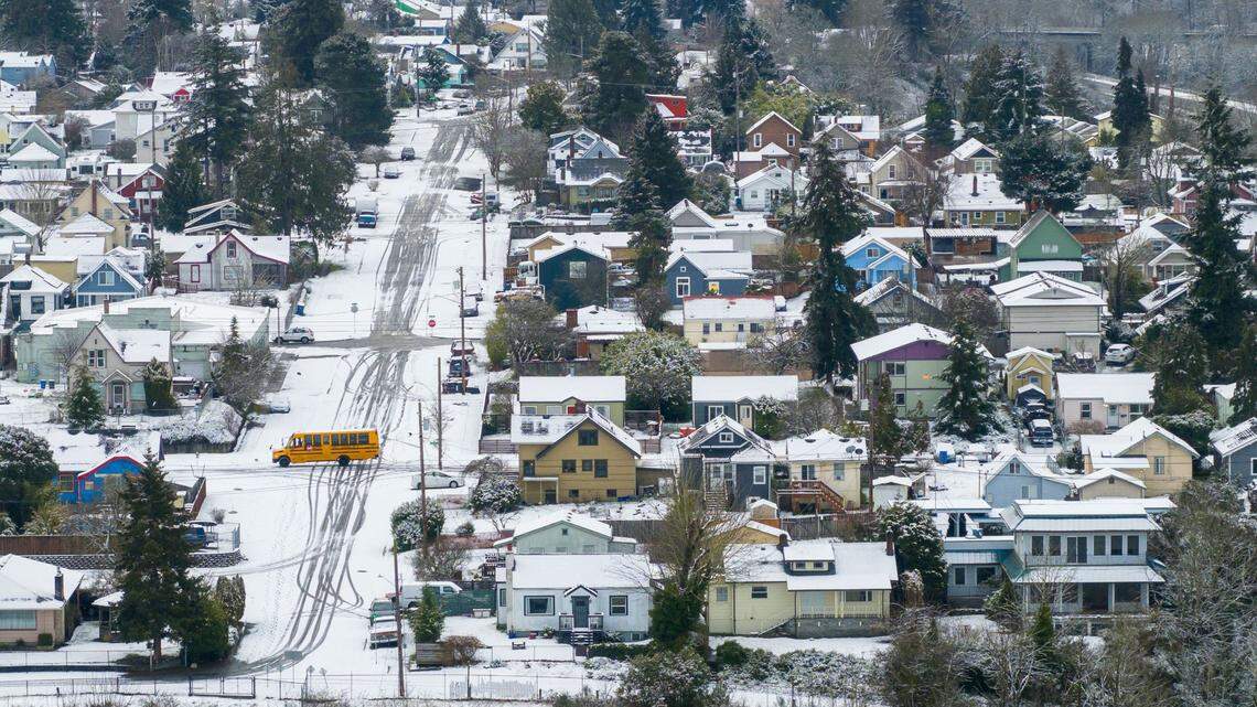 A bus drives through the snow in the McKinley Hill neighborhood of Tacoma, Wash., on Monday, Feb. 3, 2025. 