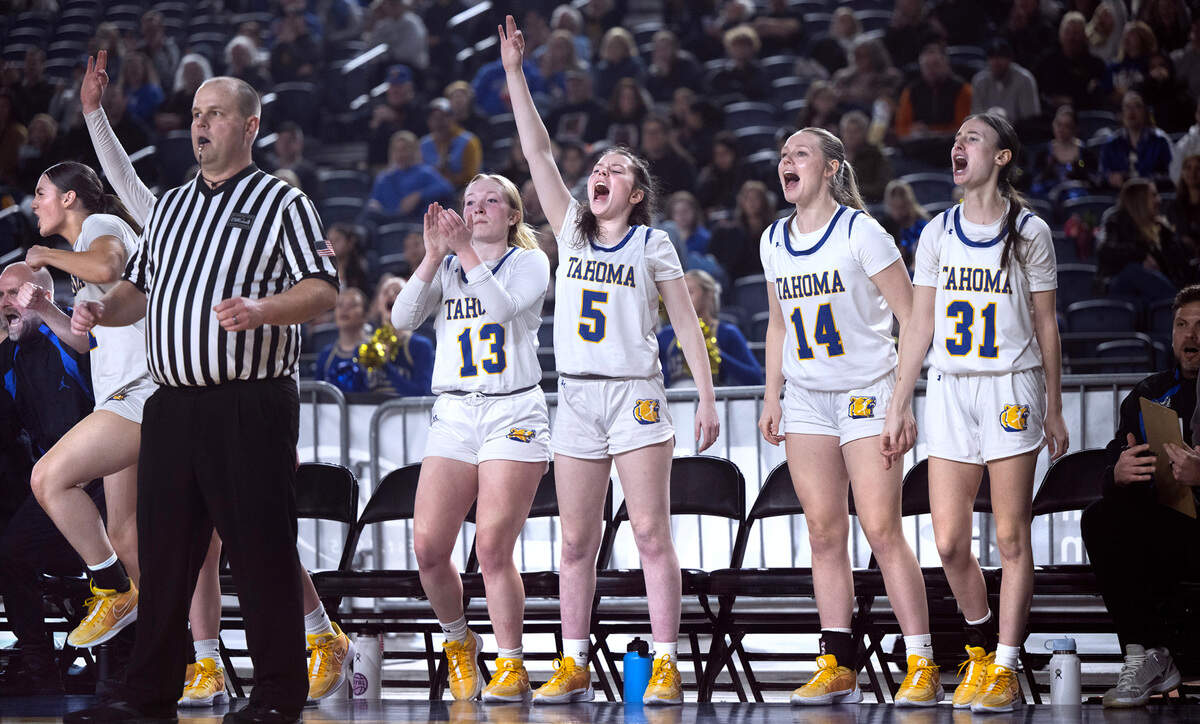 Tahoma’s Lily Cavanaugh, Maryn King, Hannah Huff and Addy Hansen celebrate a three-point shot from the bench as the Bears pull away to a 53-38 win over the Bellarmine Lions during Wednesday morning’s opening-round game of the 4A girls state basketball tournament in the TacomaDome in Tacoma, Washington, on Wednesday, Feb. 28, 2024.