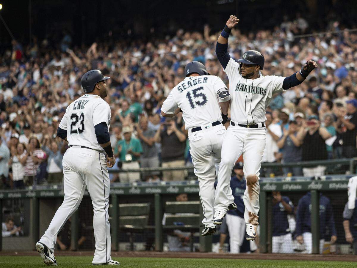 Seattle Mariners’ Kyle Seager (15), Robinson Cano, right, and Nelson Cruz celebrate after Seager hit a three-run home run off Los Angeles Dodgers starting pitcher Rich Hill during the first inning of a baseball game Saturday, Aug. 18, 2018, in Seattle. (AP Photo/Stephen Brashear)