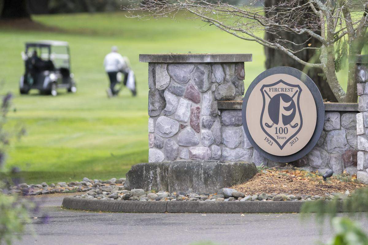 Golfers move between holes behind the entrance of Fircrest Golf Club on Friday, Nov. 7, 2025, in Fircrest, Wash.