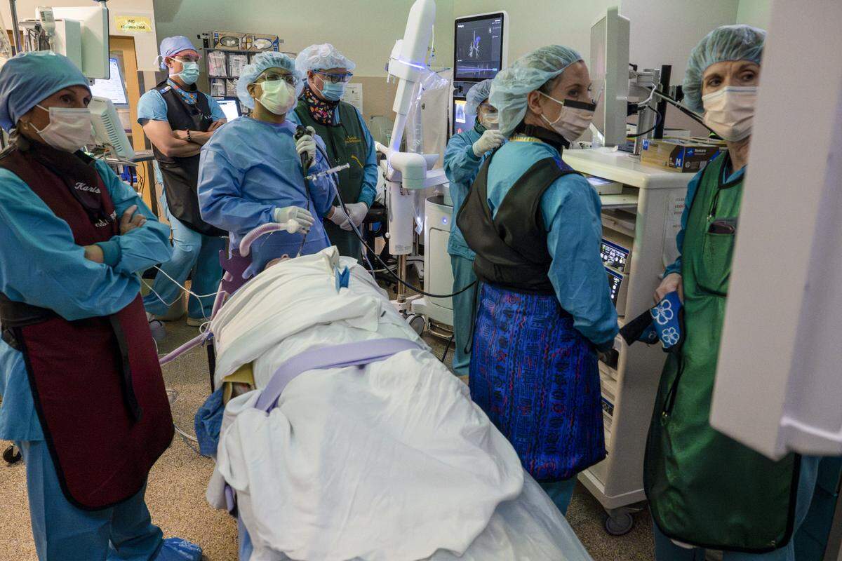 Abhishek Biswas, center, a pulmonologist with Multicare Health, and his surgery team do additional imaging following a lung biopsy procedure on Wednesday, May 21, 2025, at Good Samaritan Hospital in Puyallup, Wash.