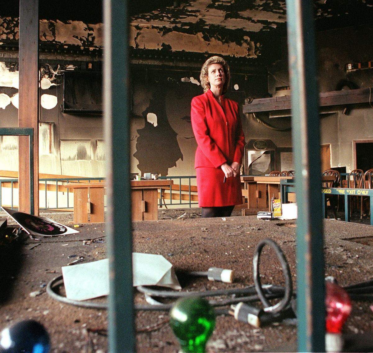 Organist Sherrie Mael Gibelyou stands near the stage where she played to pizza-eating customers at Pizza & Pipes a couple months after the building burned.