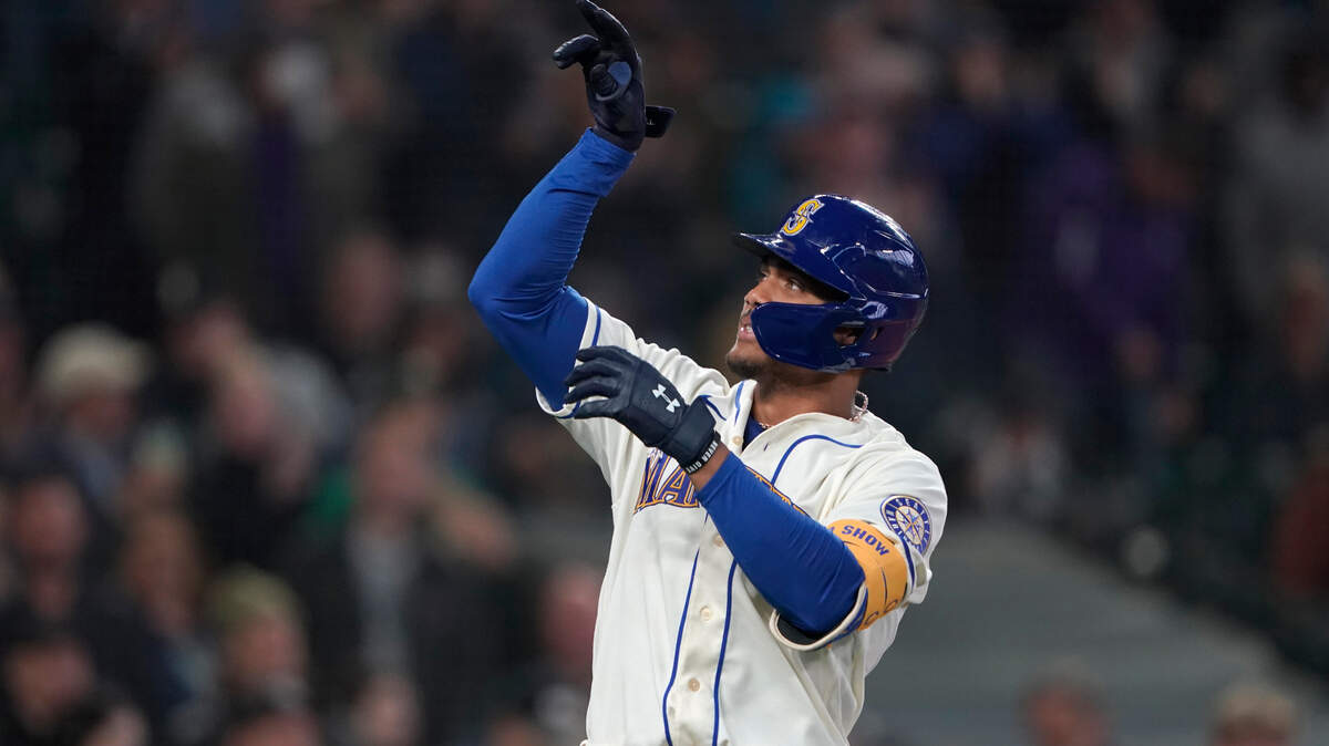 Seattle Mariners’ Julio Rodriguez gestures after crossing the plate after he hit a solo home run against the Oakland Athletics during the first inning of a baseball game, Sunday, July 3, 2022, in Seattle.