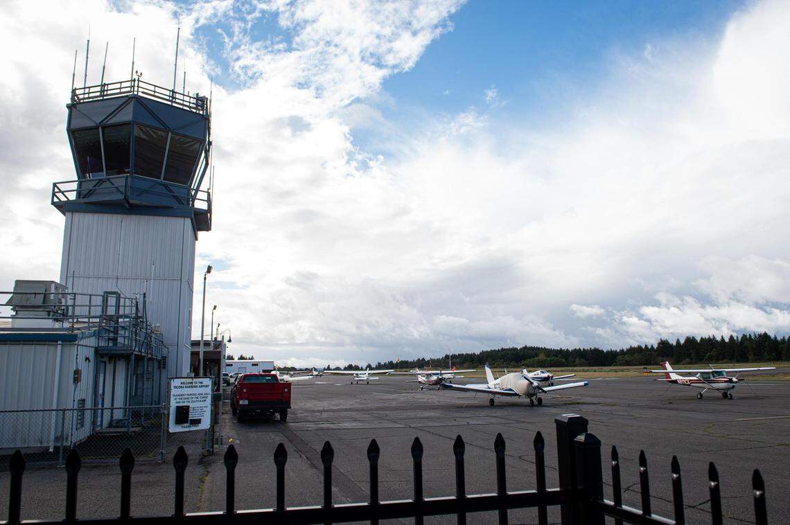 Planes are seen parked outside of hangars at the Tacoma Narrows Airport in Gig Harbor, Wash., on Saturday, Oct. 10, 2020.