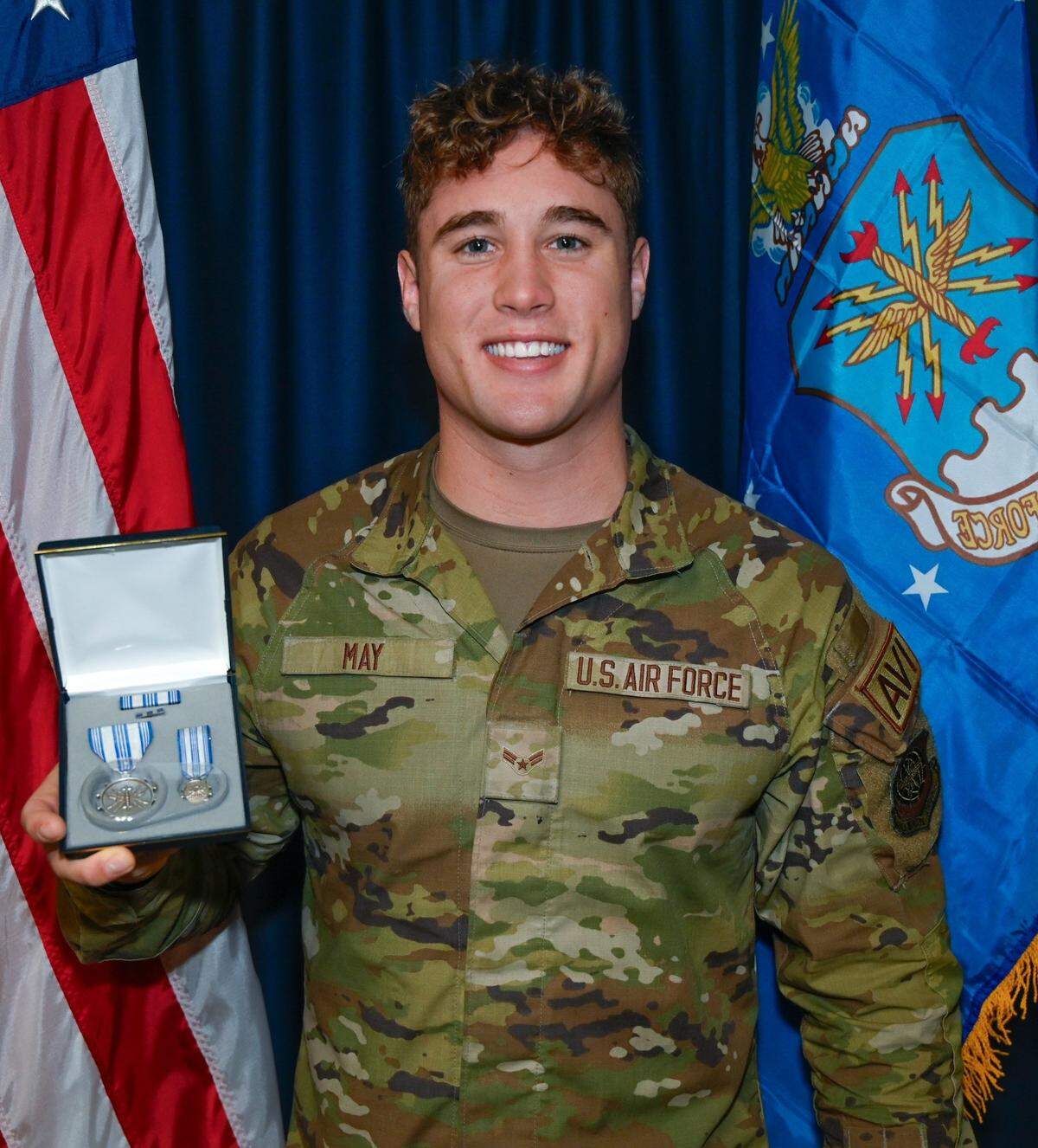 Air Force Airman 1st Class Troy May, 62nd Aircraft Maintenance Squadron heavy aircraft integrated avionics specialist, holds his Air Force Achievement Medal at Joint Base Lewis-McChord Sept. 13.
