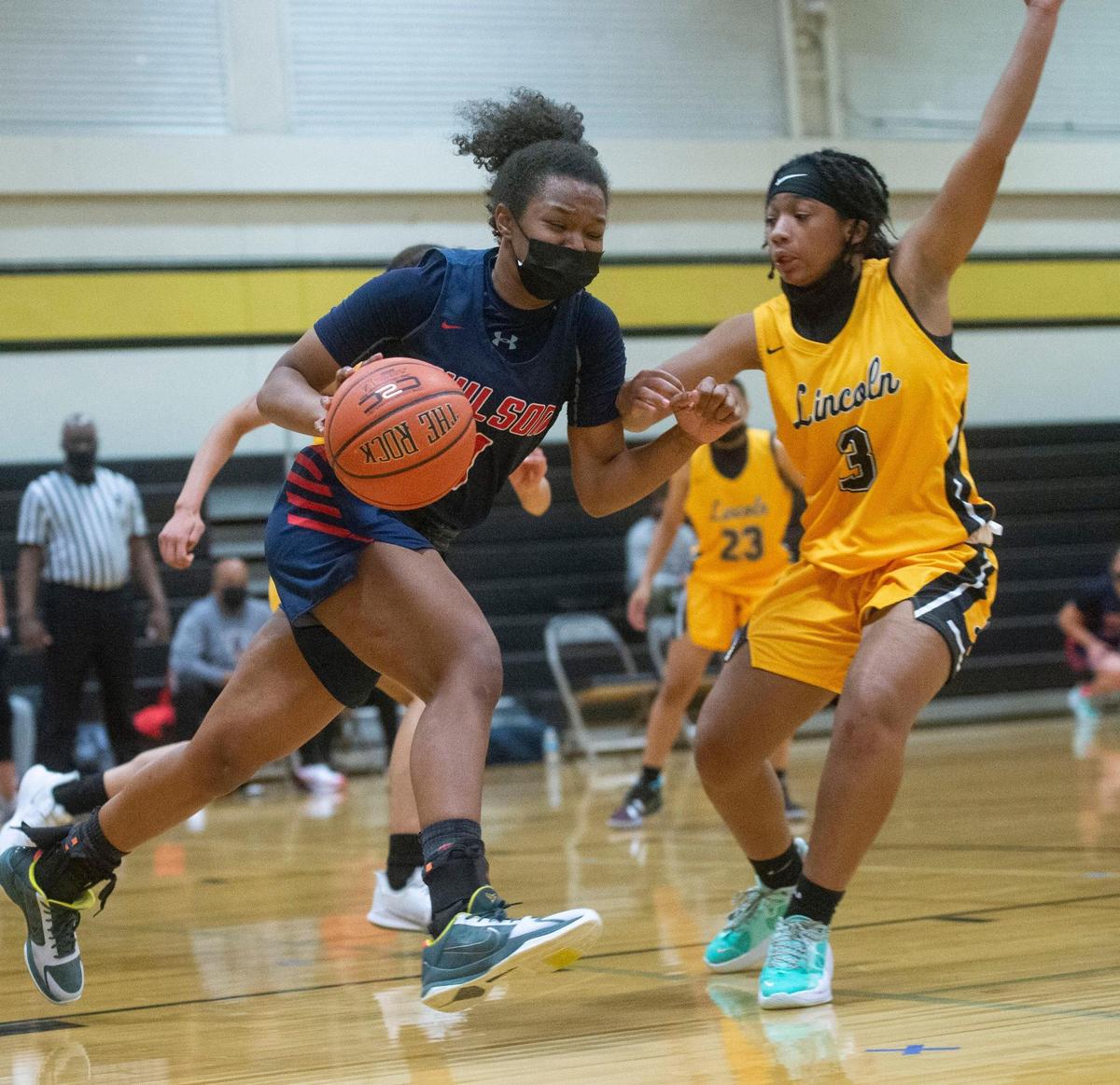 Wilson’s Jocelyn Wyatt brings the ball upcourt against Lincoln’s Simani Thomas. The Lady Abes routed the Wilson Rams, 85-46, in a crosstown rivalry game on their home court in Tacoma on Friday, May 21, 2021.