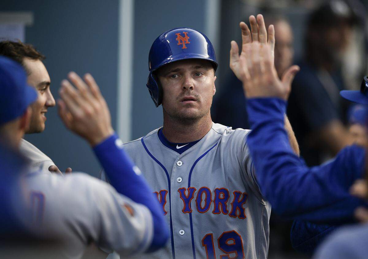 New York Mets’ Jay Bruce celebrates with the dugout after running in a score off an RBI single by Jacob deGrom during the fifth inning of a baseball game against the Los Angeles Dodgers in Los Angeles, Monday, Sept. 3, 2018. (AP Photo/Kelvin Kuo)