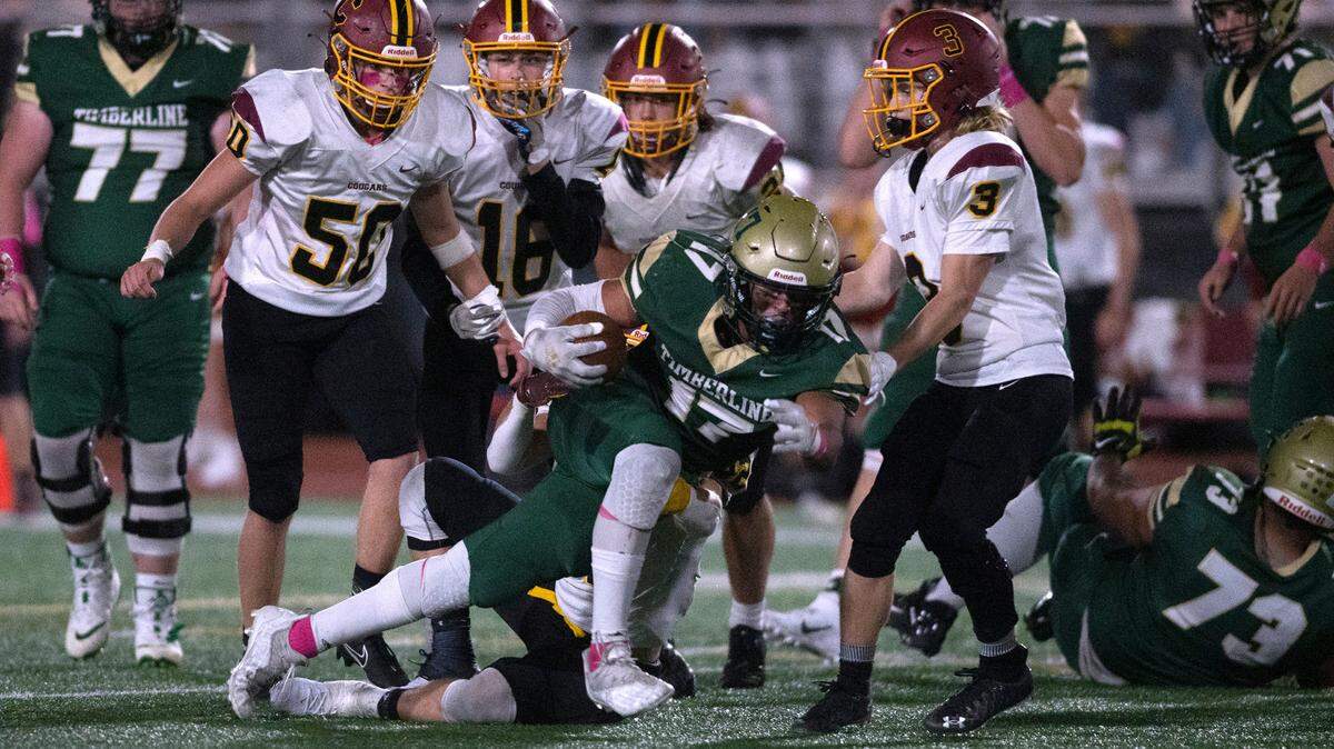 Timberline running back Kaleb McNeely fights for extra yardage against Capital linebacker Jake Kennedy during Friday night’s 3A SSC football game at South Sound Stadium in Lacey, Washington, on Oct. 8, 2021.