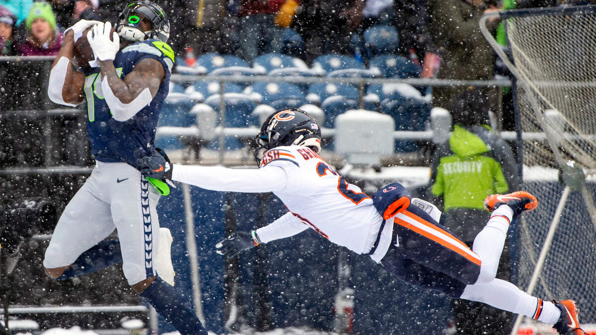 Seattle Seahawks wide receiver DK Metcalf (14) catches a pass by Chicago Bears cornerback Thomas Graham Jr. (27) during the first quarter of an NFL game on Sunday afternoon at Lumen Field in Seattle. Metcalf scored on the reception from quarterback Russell Wilson (3).