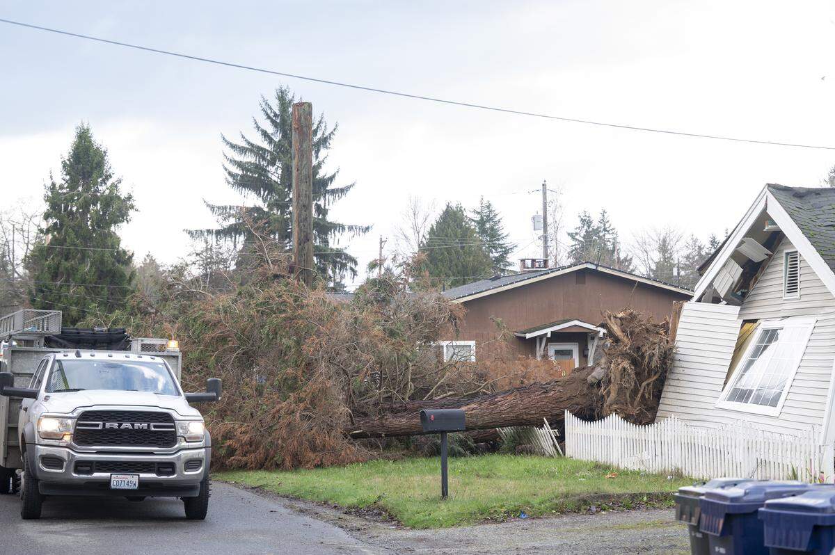A portion of East 82nd Street is closed after a tree crashed into a home in Tacoma in December 2025.