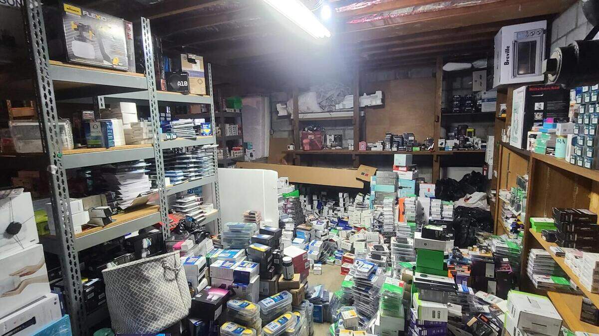 Piles of stolen merchandise are stacked in a room inside a Federal Way residence June 20, 2023. Police recovered an estimated $1.5 million in stolen products from a 32-year-old suspect’s home.