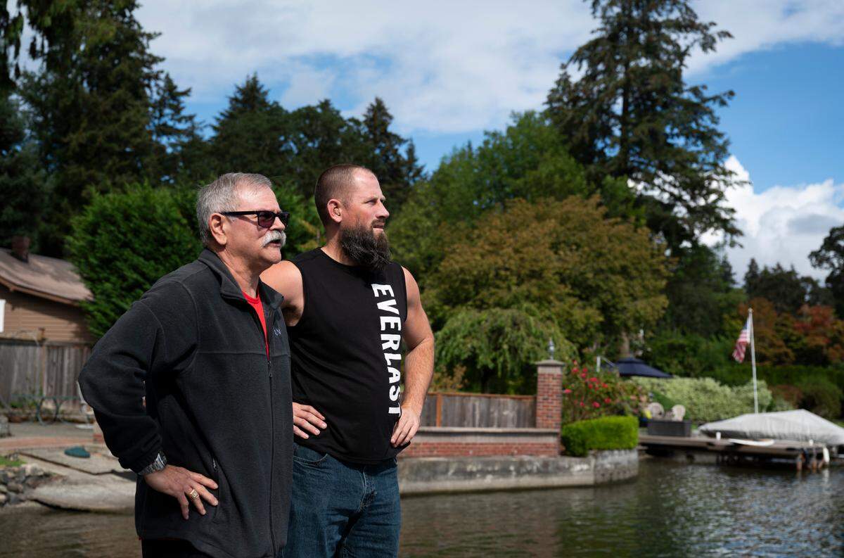 Mark Ceccarelli, left, and Mike Beckett look across Lake Steilacoom to where they crashed in a floatplane. Photographed on Wednesday, Sept. 11, 2024, in Lakewood.