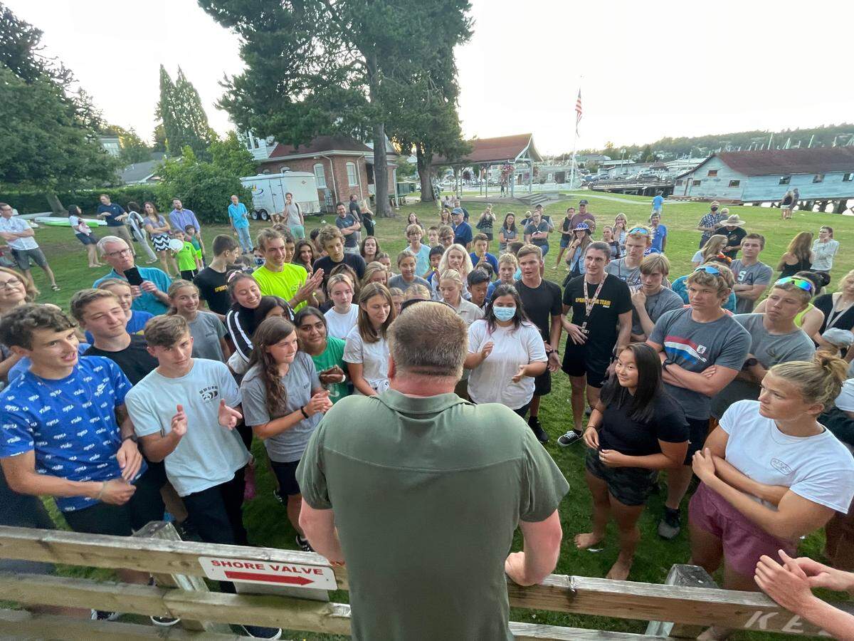 Aaron Huston, coach of the Gig Harbor Canoe and Kayak Racing team, addresses his athletes after Nevin Harrison won the gold medal in the women’s 200 meter canoe single event at the 2020 Summer Olympics in Tokyo, Japan on Wednesday, Aug. 4, 2021.