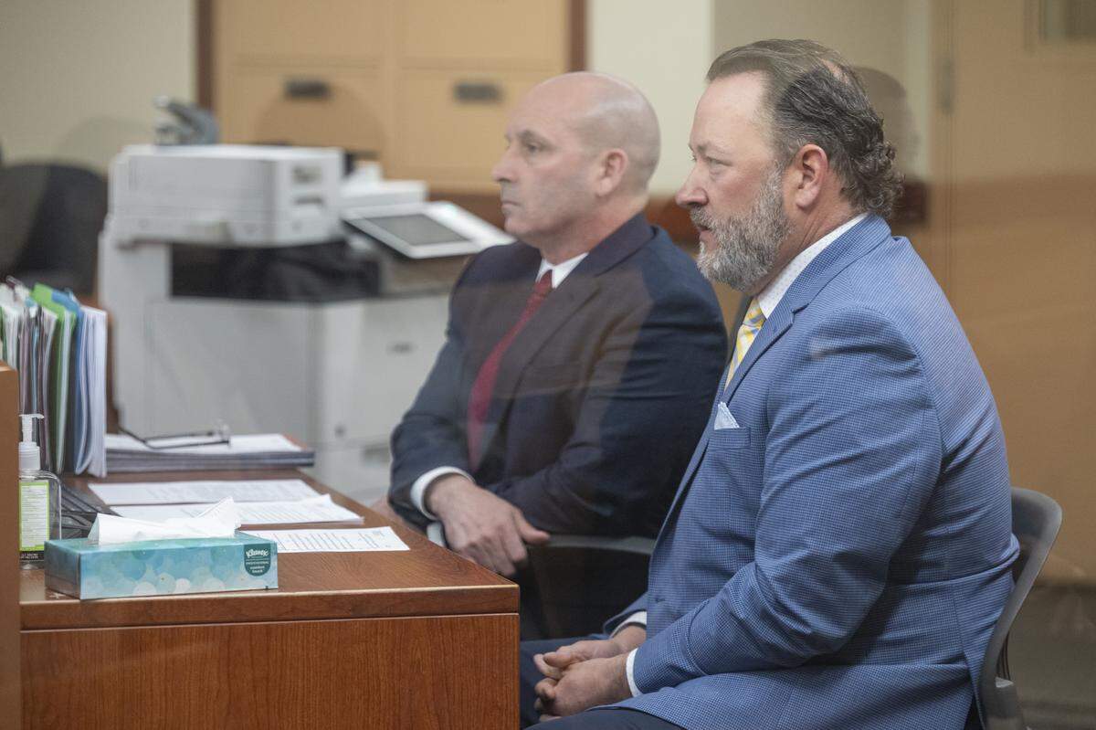 Former Pierce County Sheriff’s Office Maj. Chadwick Dickerson, right, takes part in his plea hearing and sentencing on Tuesday, April 14, 2026, at Pierce County Superior Court in Tacoma, Wash.