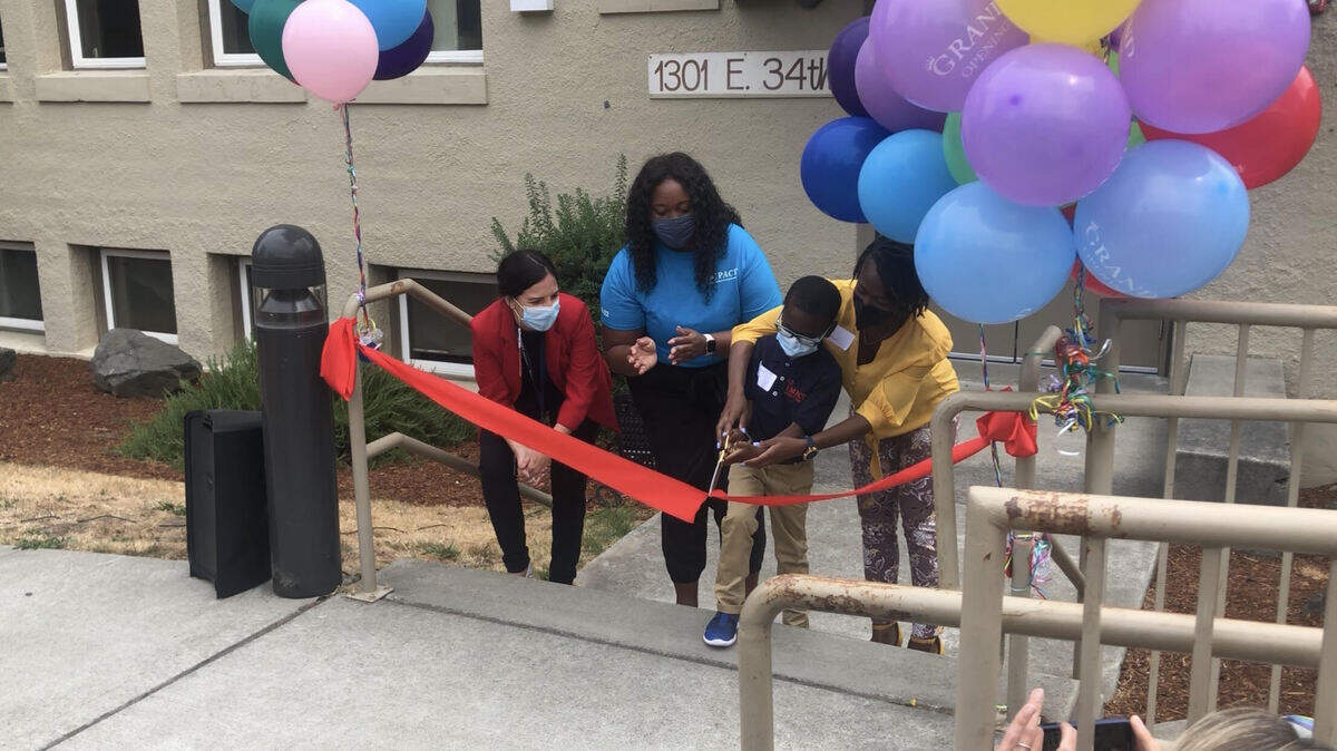 Deesha Connor and her son, Uriah, cut the ribbon for the opening of Commencement Bay Elementary, a charter school in Tacoma. August 20, 2021